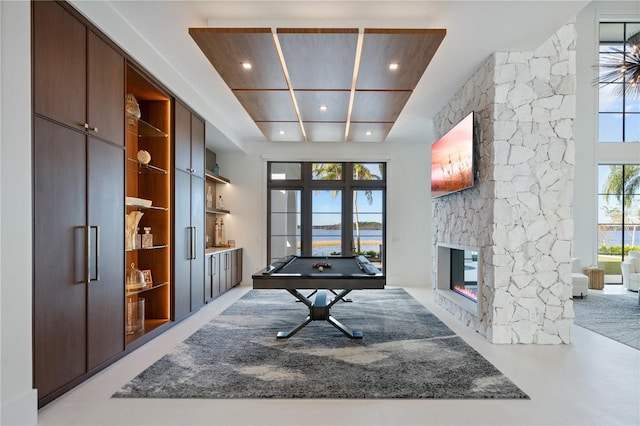 playroom with a stone fireplace