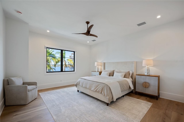 bedroom with ceiling fan and light hardwood / wood-style floors