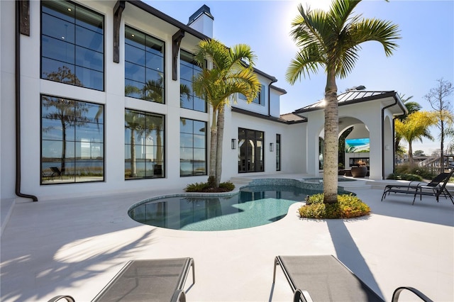 rear view of house with a patio