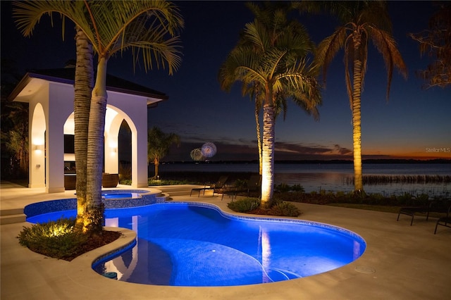 view of pool featuring a gazebo, a patio area, a water view, and an in ground hot tub