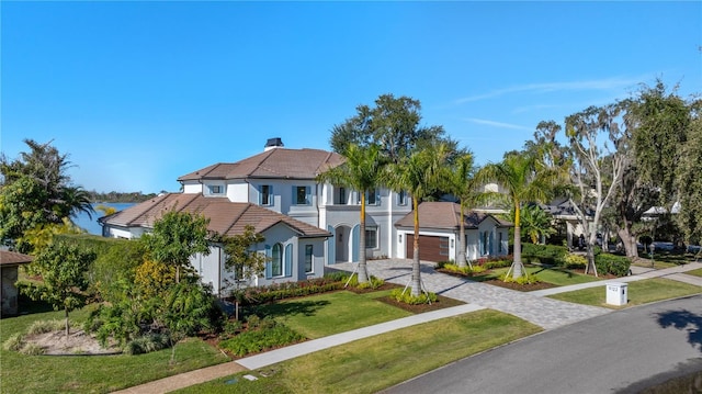 view of front of house with a garage and a front yard