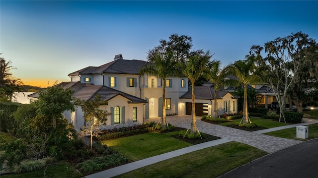 view of front of house featuring a garage and a yard