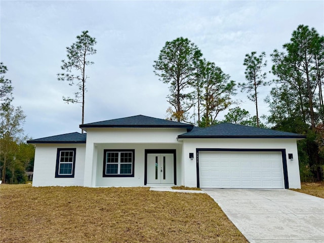 view of front facade with a garage and a front yard