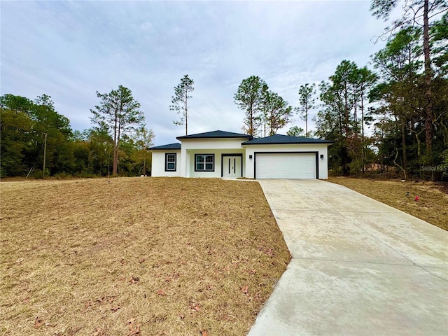 view of front facade with a garage and a front lawn