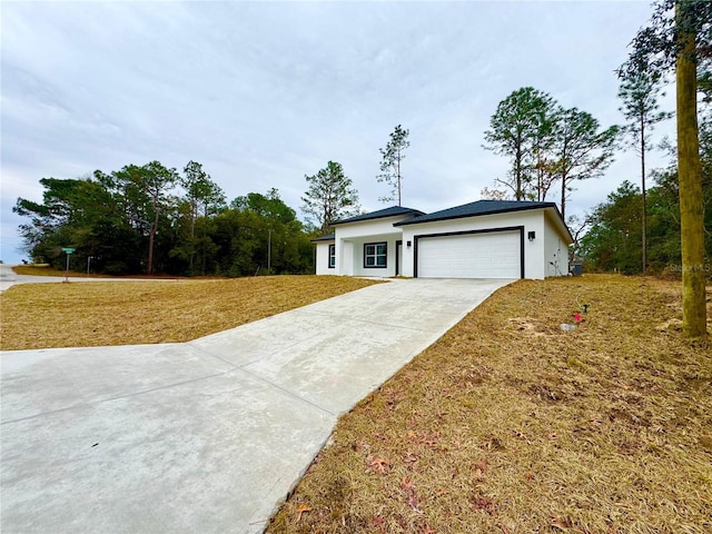 view of front facade with a garage and a front yard