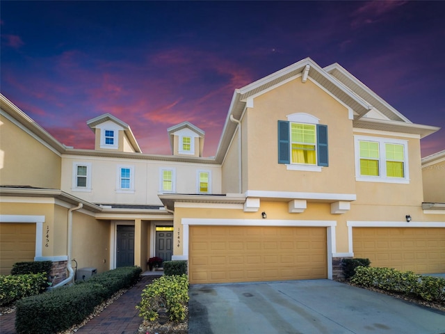 townhome / multi-family property featuring a garage