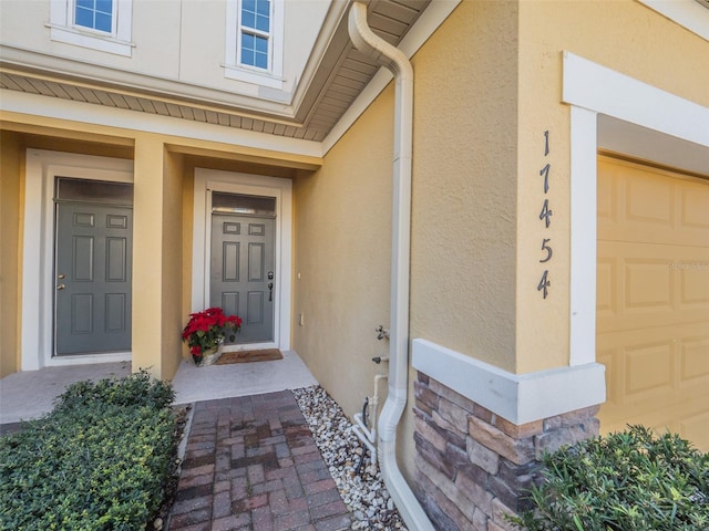 view of exterior entry featuring a garage