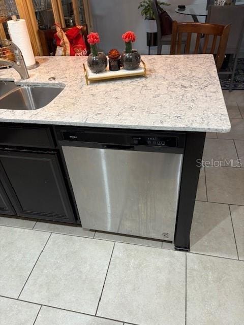 kitchen with light tile patterned flooring, dishwasher, and sink