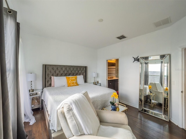 bedroom featuring dark hardwood / wood-style floors and ensuite bathroom