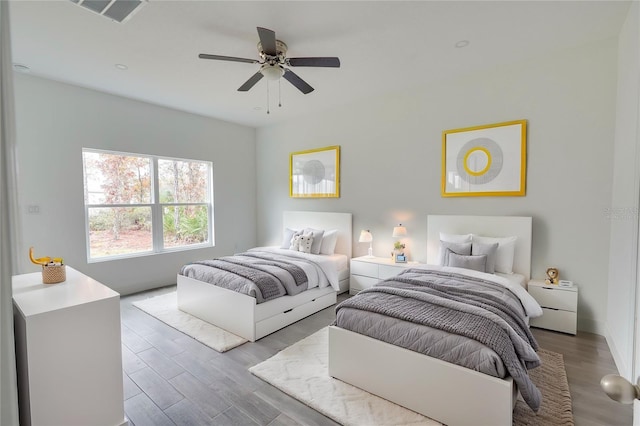 bedroom with light hardwood / wood-style flooring and ceiling fan