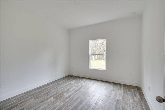 spare room with light hardwood / wood-style flooring