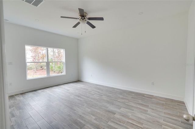 spare room with light hardwood / wood-style flooring and ceiling fan