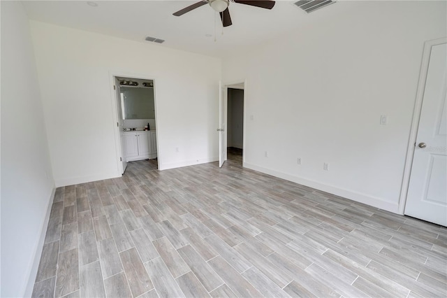 unfurnished bedroom featuring ensuite bathroom, light hardwood / wood-style flooring, and ceiling fan