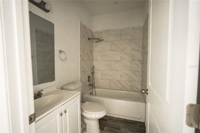 full bathroom with toilet, vanity, and tiled shower / bath combo