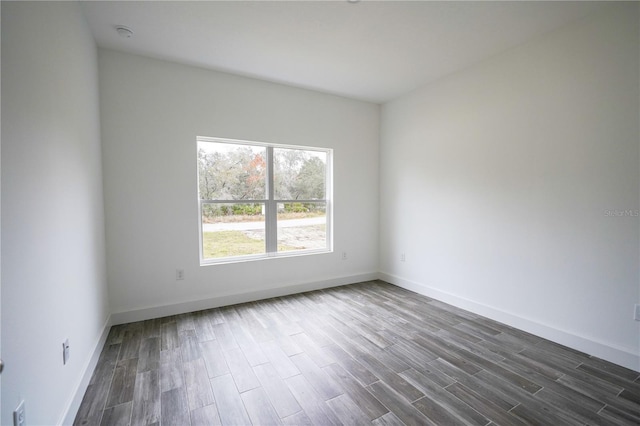 empty room with dark hardwood / wood-style flooring