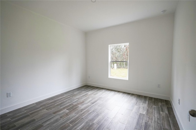 empty room with dark wood-type flooring