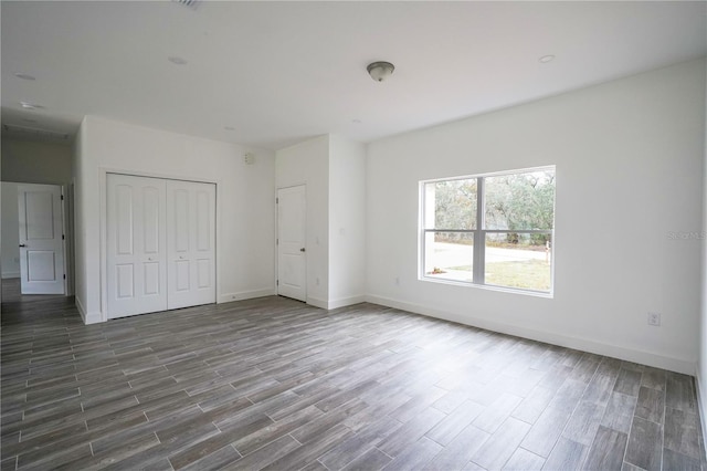 unfurnished bedroom featuring hardwood / wood-style flooring and a closet