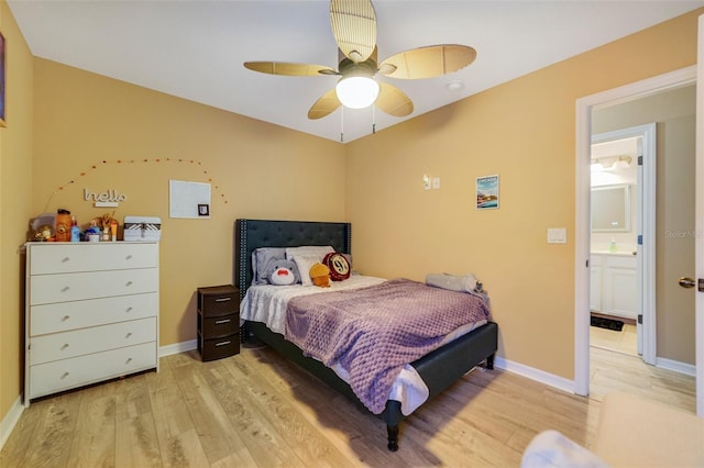 bedroom with ceiling fan, ensuite bath, and light wood-type flooring