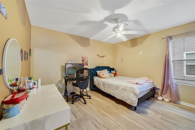 bedroom with ceiling fan and light wood-type flooring