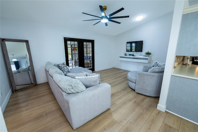 living room featuring french doors, ceiling fan, lofted ceiling, and light hardwood / wood-style flooring