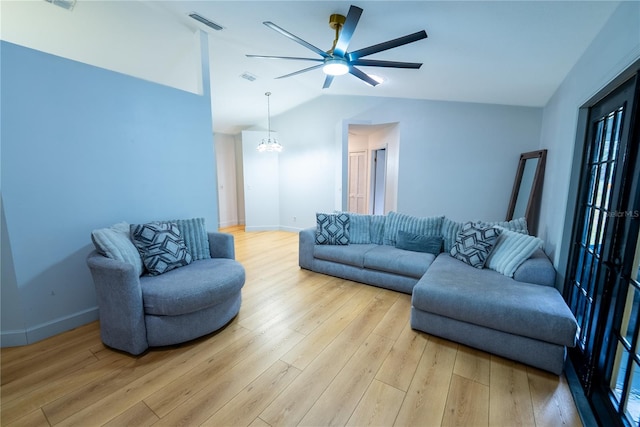 living room with lofted ceiling, ceiling fan with notable chandelier, and light hardwood / wood-style flooring