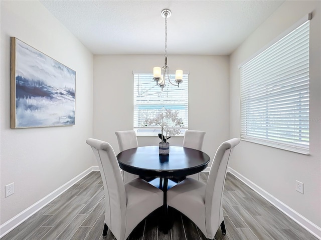 dining room featuring an inviting chandelier and hardwood / wood-style flooring