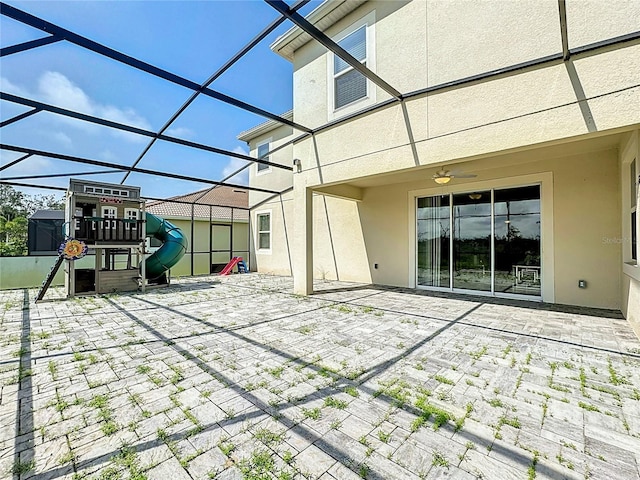 view of patio / terrace with a lanai and a playground