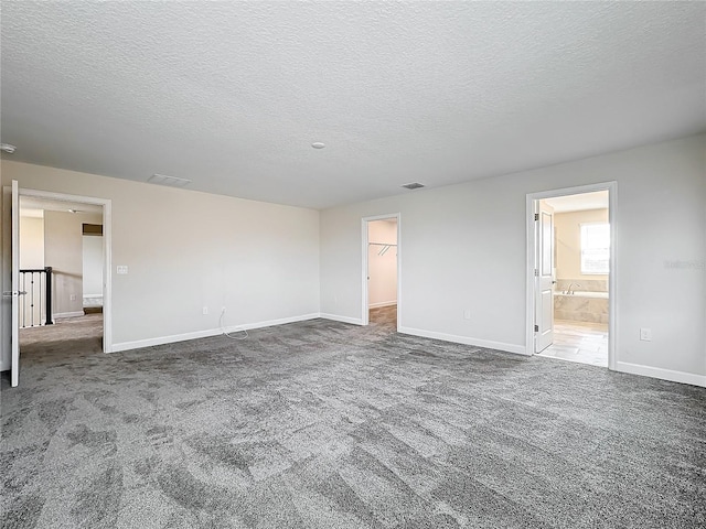 8886 Fallen Oak Dr, Davenport, FL 33896 - carpeted empty room with a textured ceiling