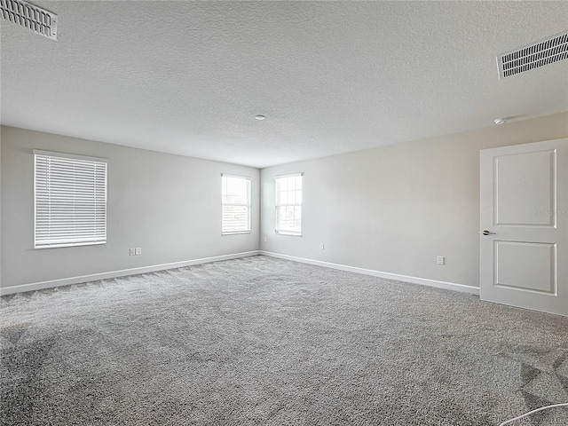 8886 Fallen Oak Dr, Davenport, FL 33896 - carpeted empty room featuring a textured ceiling and a smoke detector