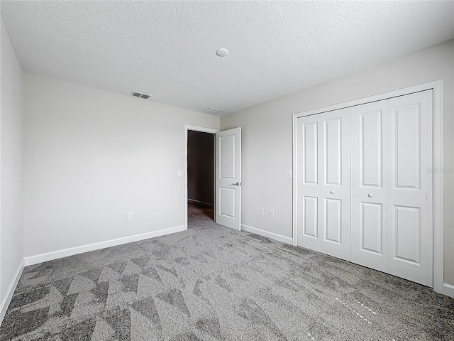 8886 Fallen Oak Dr, Davenport, FL 33896 - unfurnished bedroom with carpet floors, a textured ceiling, and a closet