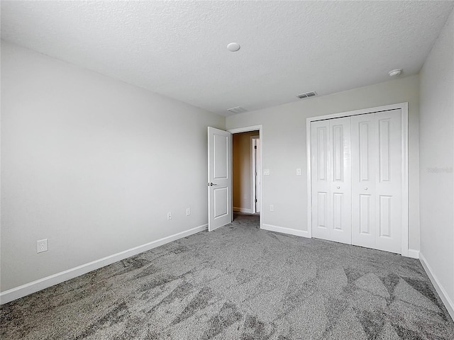 8886 Fallen Oak Dr, Davenport, FL 33896 - unfurnished bedroom with a textured ceiling, carpet flooring, and a closet