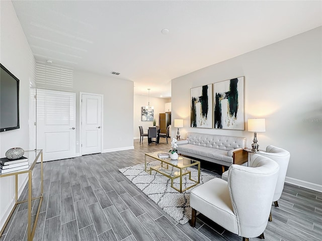 8886 Fallen Oak Dr, Davenport, FL 33896 - living area with wood finished floors and a chandelier