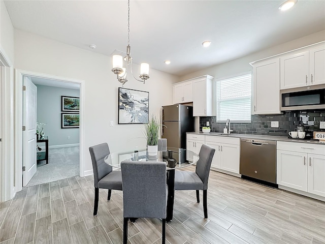 8886 Fallen Oak Dr, Davenport, FL 33896 - dining area featuring light wood-style flooring, a chandelier, and recessed lighting