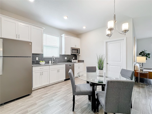 8886 Fallen Oak Dr, Davenport, FL 33896 - dining area featuring a chandelier, light wood-type flooring, and recessed lighting