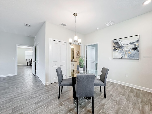8886 Fallen Oak Dr, Davenport, FL 33896 - dining space with a chandelier and light wood-type flooring