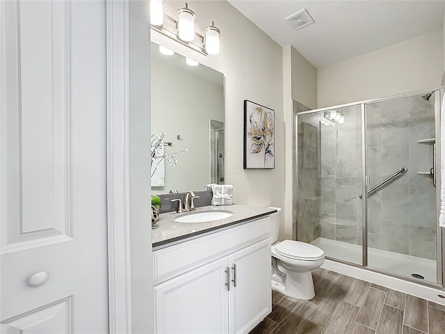 8886 Fallen Oak Dr, Davenport, FL 33896 - bathroom with vanity, a shower stall, and wood finished floors