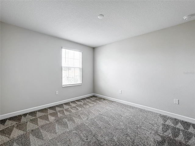8886 Fallen Oak Dr, Davenport, FL 33896 - spare room featuring carpet flooring, a textured ceiling, and a smoke detector