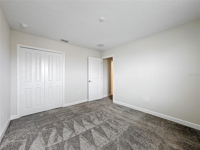 8886 Fallen Oak Dr, Davenport, FL 33896 - unfurnished bedroom with carpet flooring, a closet, and a textured ceiling