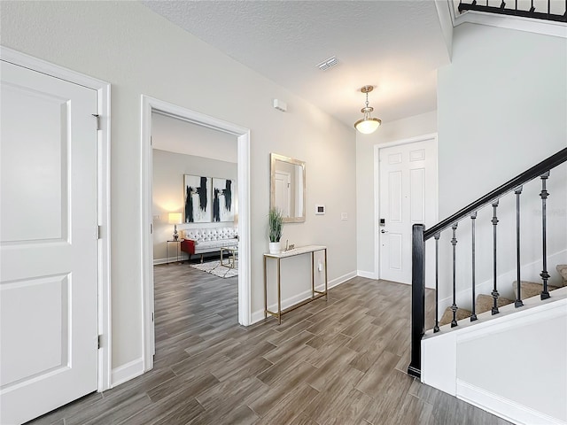 8886 Fallen Oak Dr, Davenport, FL 33896 - foyer featuring stairway and dark wood finished floors