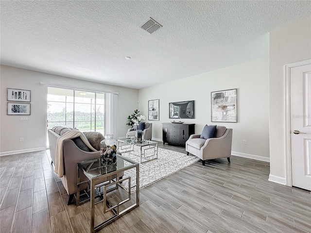 8886 Fallen Oak Dr, Davenport, FL 33896 - living room featuring light wood-style flooring and a textured ceiling