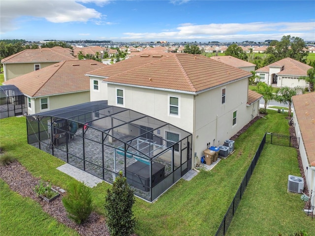 8886 Fallen Oak Dr, Davenport, FL 33896 - back of property featuring glass enclosure, stucco siding, a patio area, and a fenced backyard