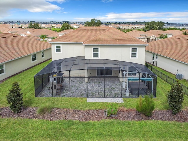 8886 Fallen Oak Dr, Davenport, FL 33896 - back of house featuring glass enclosure, a patio area, and a residential view