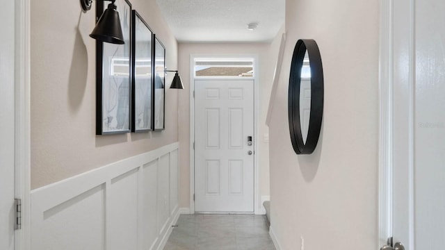 entryway featuring a textured ceiling