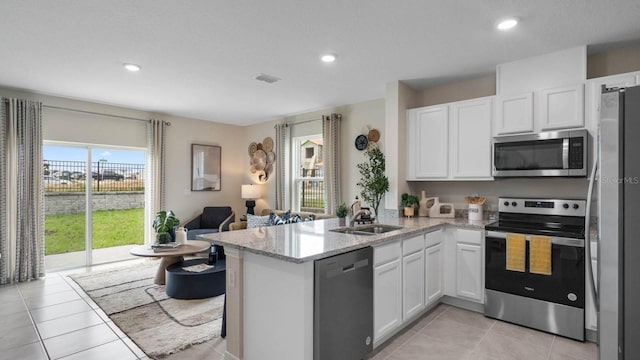 kitchen featuring kitchen peninsula, white cabinetry, and stainless steel appliances