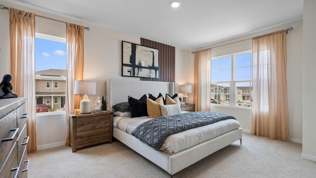 carpeted bedroom with multiple windows