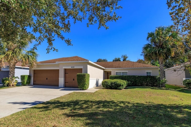 view of front of property with a garage and a front lawn