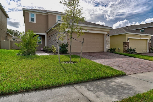 view of front of property with a garage and a front yard