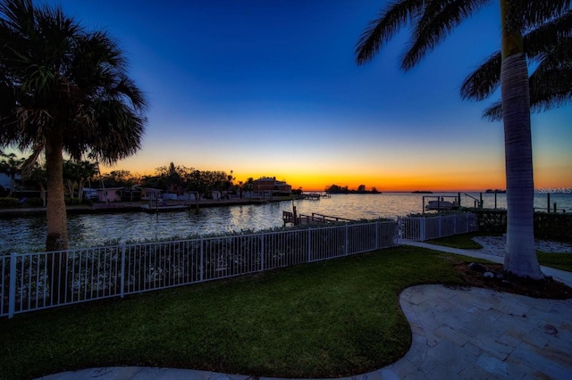 view of yard with a water view and fence