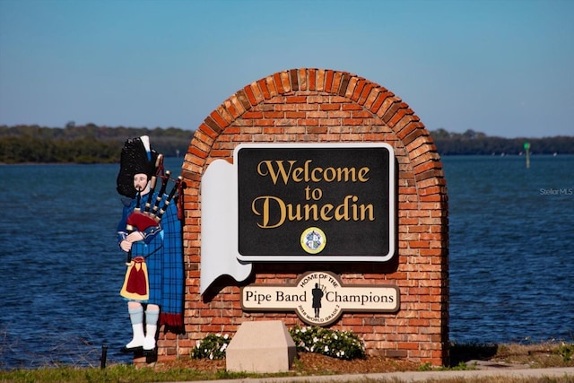 community sign with a water view