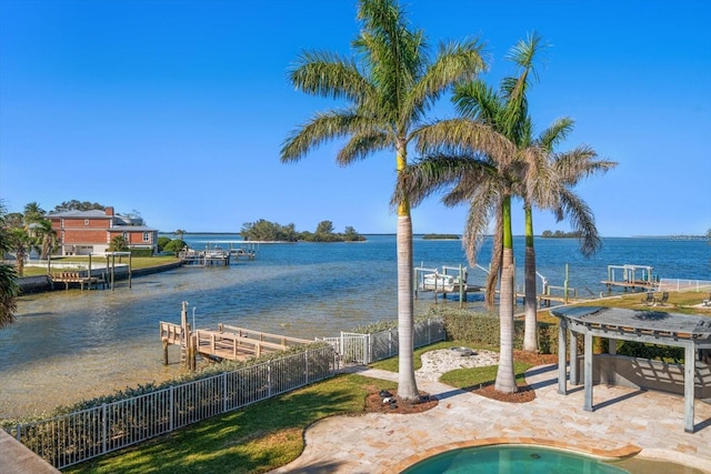 view of water feature featuring a boat dock, boat lift, and fence